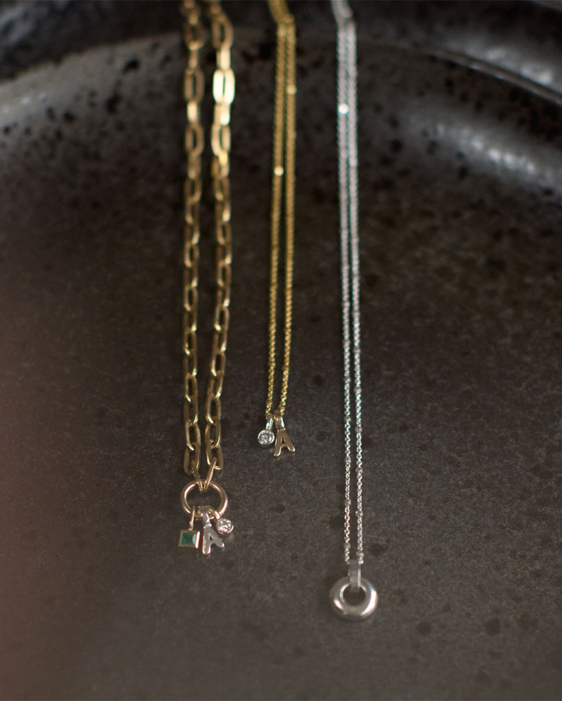 Recycled 925 sterling silver and 9ct solid gold chains with charms handmade in London by Maya Magal London