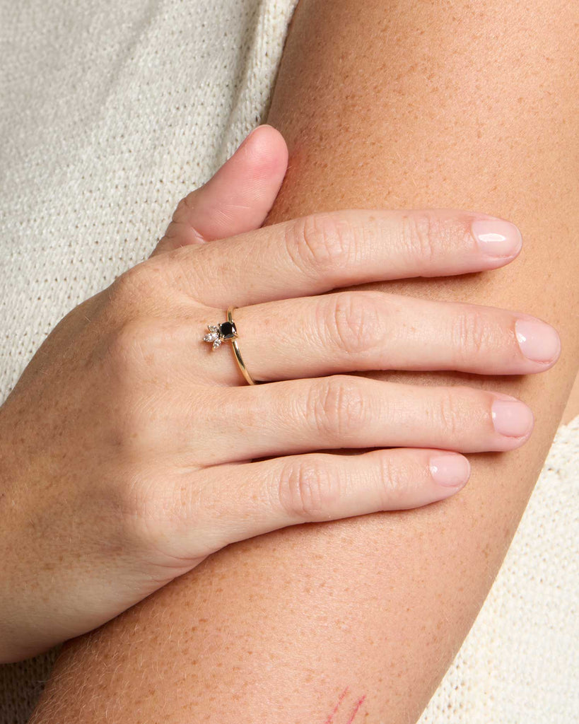 solid gold engagement ring featuring a jet black diamond and three sparkling marquise cut white diamonds handcrafted in London by Maya Magal London