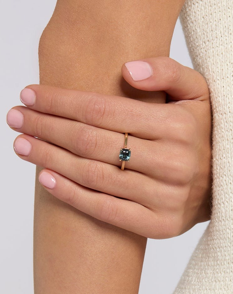 solid gold solitaire engagement ring featuring an oval blue spinel handcrafted in London by Maya Magal London