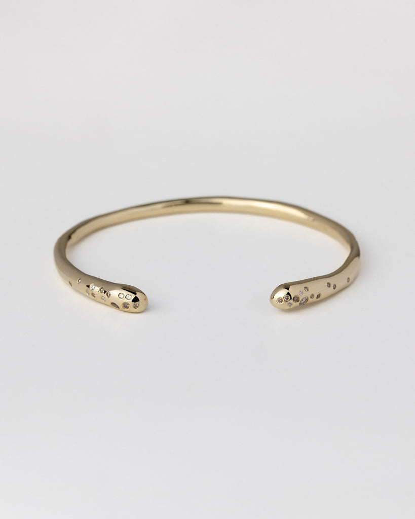 hand-carved recycled 9ct solid yellow gold bangle with finely set white and champagne natural diamonds handcrafted in London by Maya Magal London