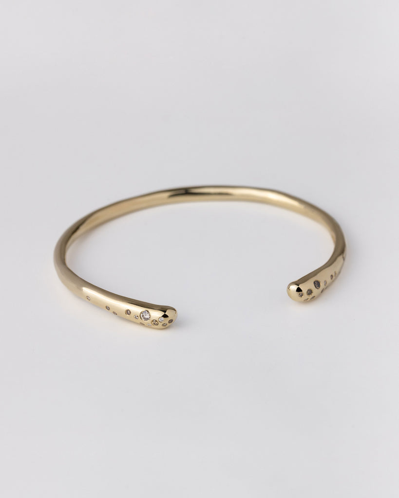 hand-carved recycled 9ct solid yellow gold bangle with finely set white and champagne natural diamonds handcrafted in London by Maya Magal London