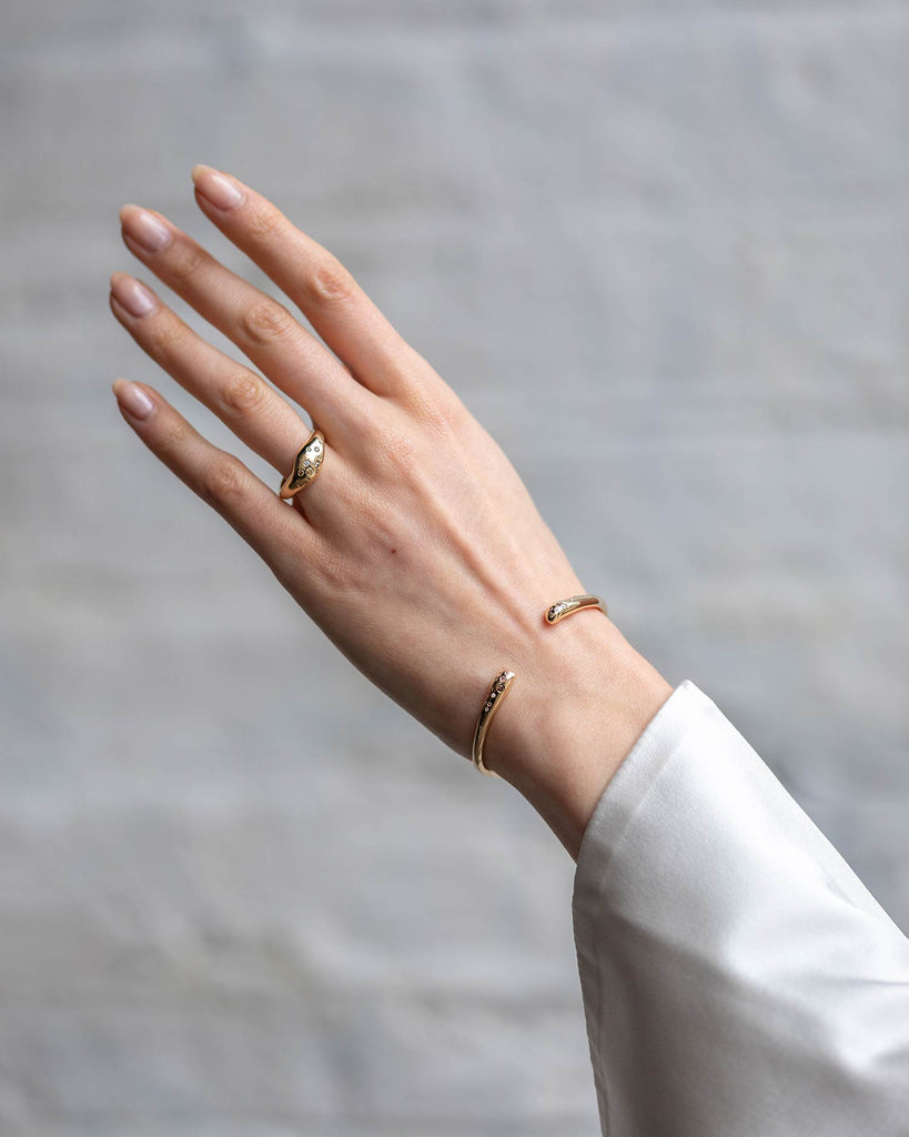 hand-carved recycled 9ct solid yellow gold bangle with finely set white and champagne natural diamonds handcrafted in London by Maya Magal London