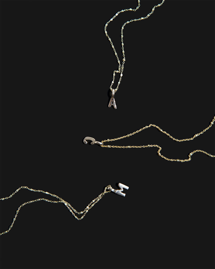 Recycled 9ct solid gold chains with 9ct solid gold initial charms handmade in London by Maya Magal London