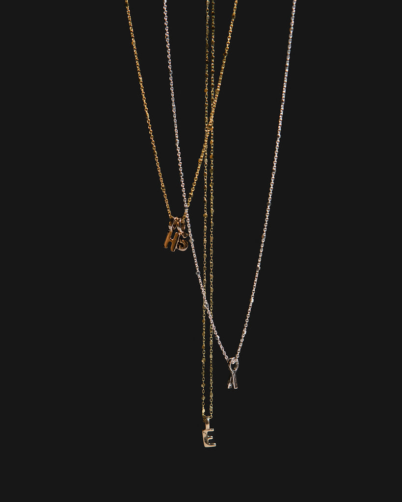 Recycled 925 sterling silver and 9ct solid gold chains with initial charms handmade in London by Maya Magal London