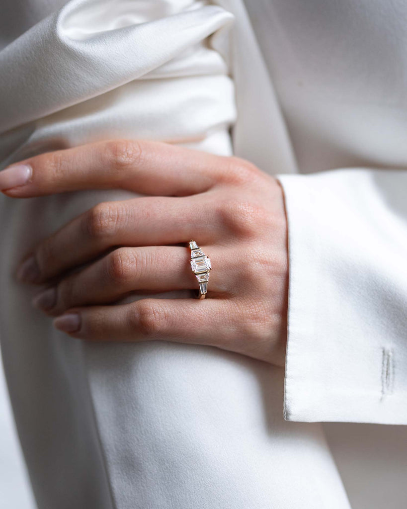 Emerald cut lab grown diamond with trapezoid and tapered baguette side stones ring set in a recycled 9 ct solid yellow gold band handcrafted in London by Maya Magal