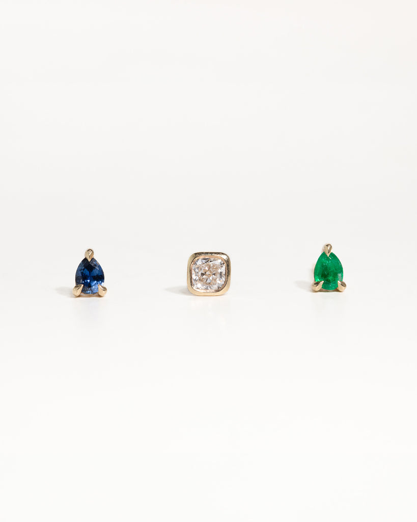 pear cut natural sapphire stud earring encased in recycled solid gold handcrafted in London by Maya Magal London